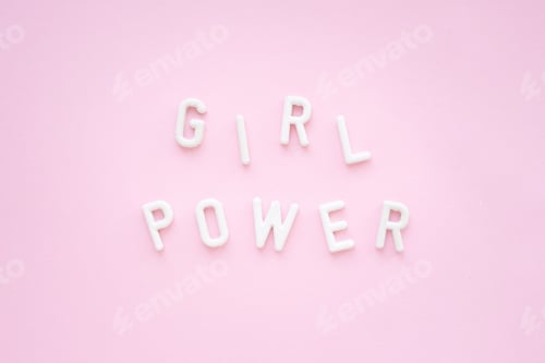 Preview: Inscription: girl power from white plaster letters on a pink background. Feminist slogan.