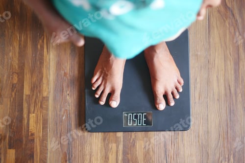 Preview: child boy feet on weight scale top view