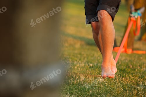 Preview: Barefoot person walking on a slackline, slacklining in the daytime, the concept of balance