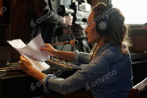 Preview: Woman reading text in paper documents