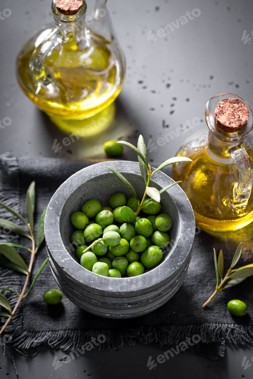 Preview: Healthy and fresh raw olives with berries and oil.