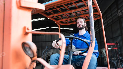 Preview: Portrait of a man working with a forklift in a warehouse. Concept industrial and commercial.