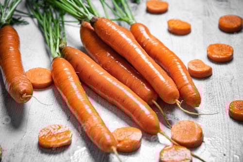 Preview: Fresh carrots on wooden table.
