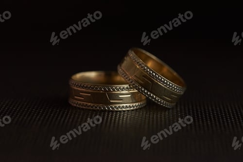 Preview: Closeup of wedding rings on a black backdrop