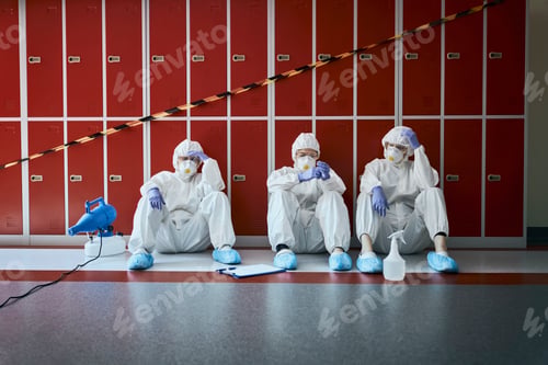Preview: Overworked healthcare worker resting on the floor