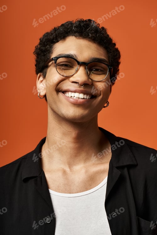 Preview: Vibrant Smiles: Stylish Young Man Embracing Orange Joy