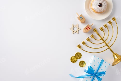 Preview: A festive Hanukkah arrangement featuring a menorah, dreidels, Star of David