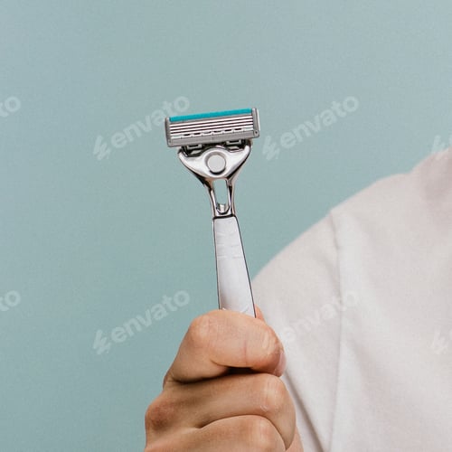 Preview: Man holding a shaving razor