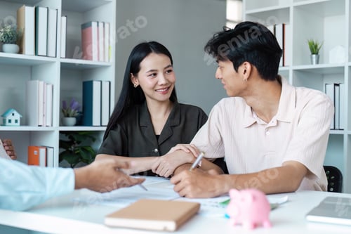 Preview: Young Couple Discussing Financial Plans with Advisor in Modern Office Setting