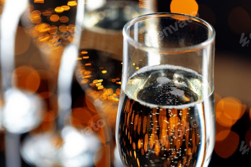 Preview: Close up photo of Champagne glasses against bokeh background