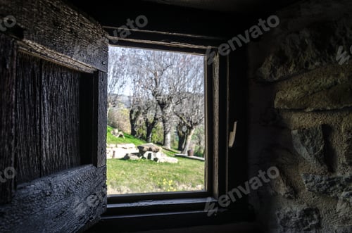 Preview: View from the stone window to the garden with trees