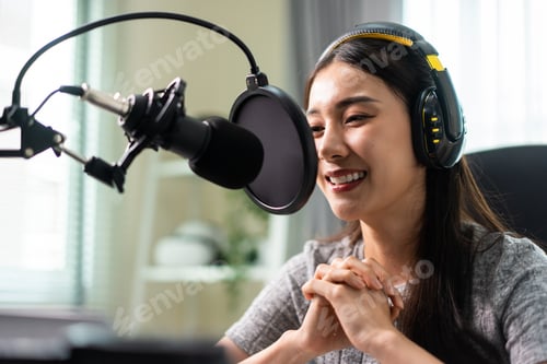Preview: Asian attractive audio DJ woman speaks into microphone to broadcasting.