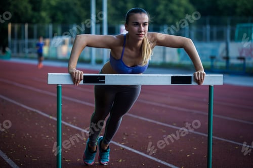 Preview: beautiful sporty girl warming up at the stadium,