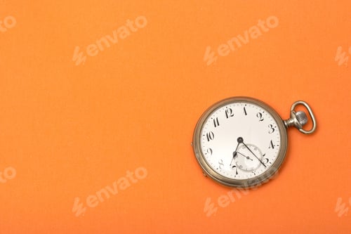Preview: Clock on an orange surface - time management concept
