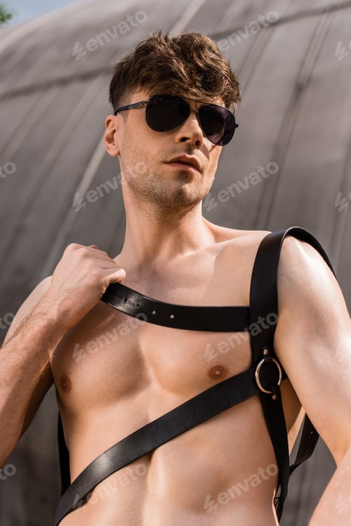 Preview: sexy shirtless man in black sunglasses and sword belt