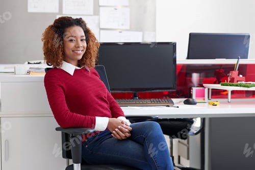 Preview: Success- its up to you. Portrait of a young woman sitting at her workstation in an office.