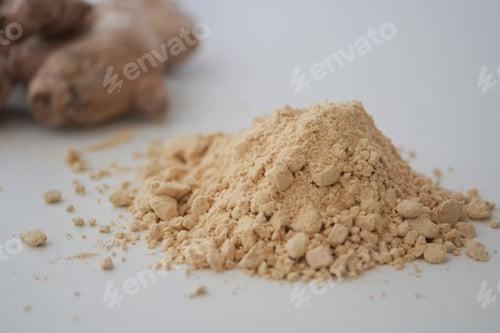Preview: Ginger root and ground ginger on a plain surface