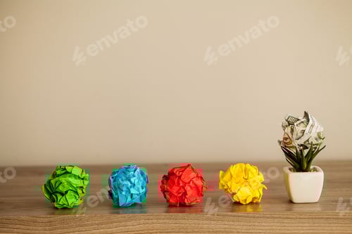 Preview: Great idea concept. Crumpled colorful paper on wooden table. Copy space