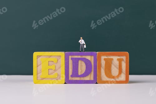 Preview: View of teacher figurine on an EDU wooden letter blocks