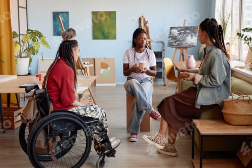 Preview: Group of Young Multiethnic Women Having Conversation in Art Studio Setting