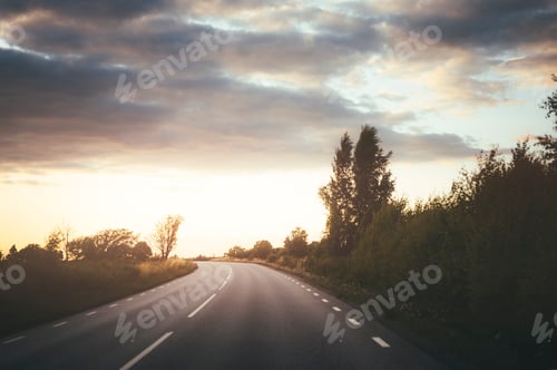 Preview: An empty road leading into a breathtaking sunset.