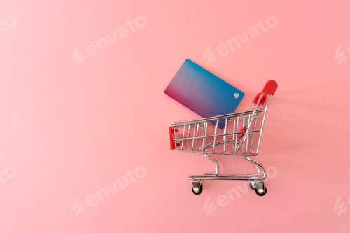 Preview: shopping cart with credit cart on pink background