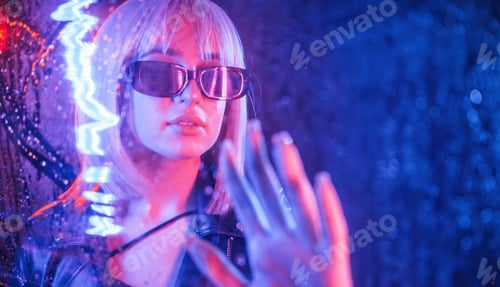 Preview: Stylish woman with white hair is behind wet transparent plastic sheet