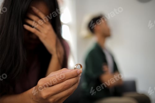 Preview: Wife's hand holding wedding ring in disappointment and upset her husband, which may lead to divorce.
