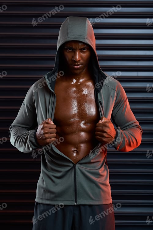 Preview: The modern day Superman. Studio shot of an athletic young man posing against a grey background.