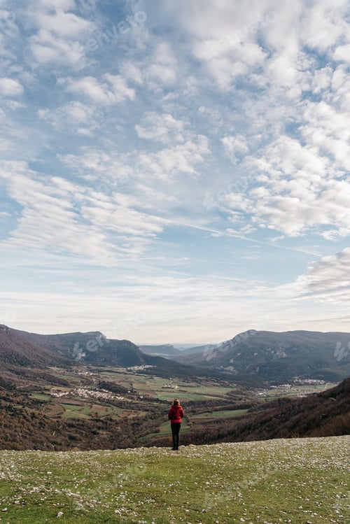 Preview: Anonymous woman admiring view of valley and mountains
