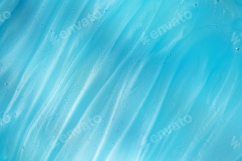 Vorschau: Die Textur eines transparenten Gels auf blauem Hintergrund. Swatch. Eine Probe eines kosmetischen Produkts.