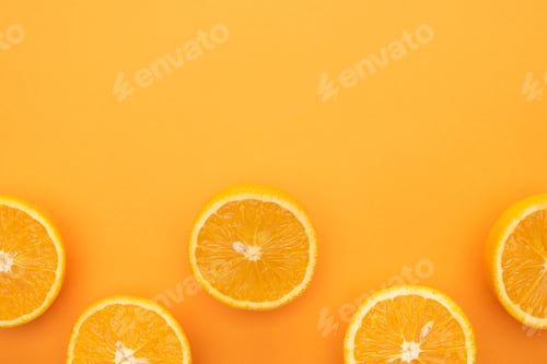 Preview: top view of ripe juicy orange slices on colorful background with copy space