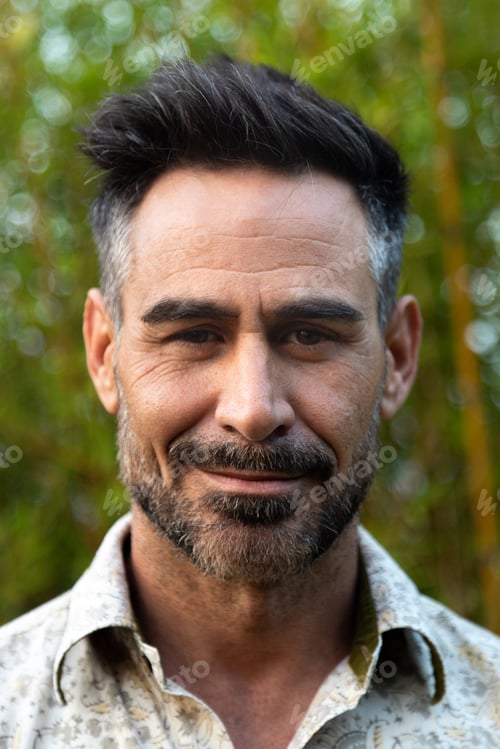 Preview: Vertical headshot of middle age white man with beard in nature.