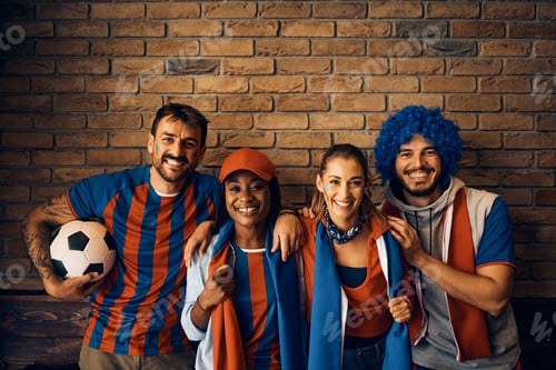 Preview: Group of happy football fans during the world cup looking at camera.