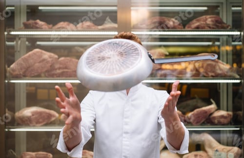 Preview: Chef in jacket with frying pan in air