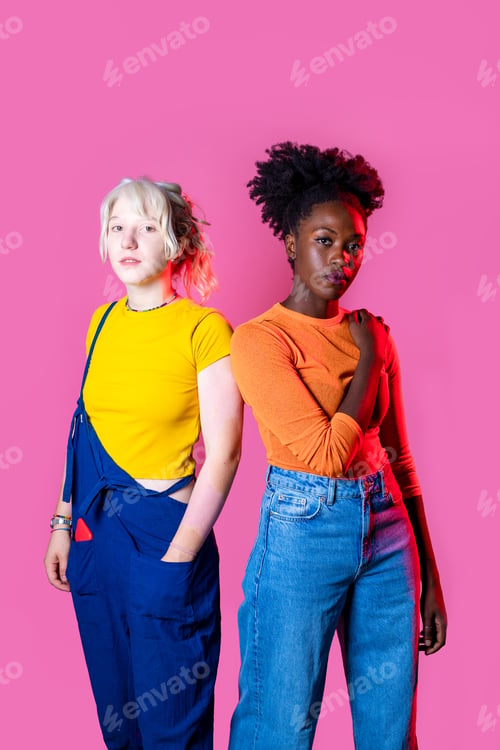 Preview: Two young diverse multicultural caucasian and black women best friends posing isolated background