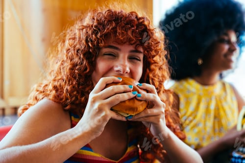 Preview: Multiethnic group of friends having meal at diner restaurant