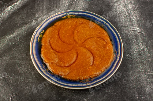 Preview: a top view sweet delicious halva yummy eastern food inside plate on the dark background sweet sugar
