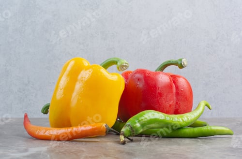 Preview: Tasty whole peppers on marble background