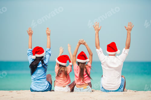 Preview: Happy family with two kids in Santa Hat on summer vacation