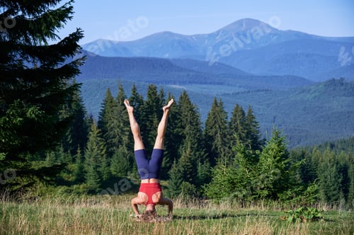 Preview: Slim, blonde lady training, wearing sportswear in summer.