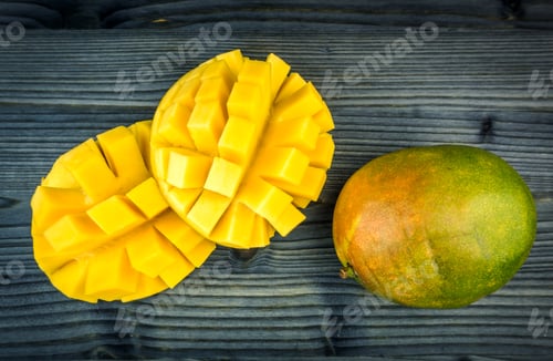 Preview: Mango cut in dices on wooden backdrop