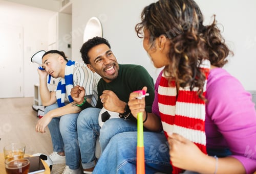 Preview: Diverse friends watching sports game together at home