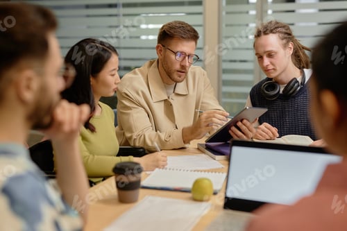 Preview: University Male Professor Assisting Students at University