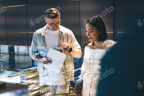 Preview: Male and female architects discussing real estate project during collaboration brainstorming