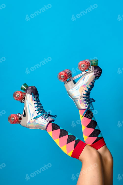 Preview: Feminine legs in a roller skates shoes with blue background