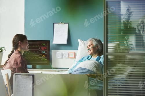 Preview: Caucasian Woman Visiting Senior Female Relative in Hospital Room