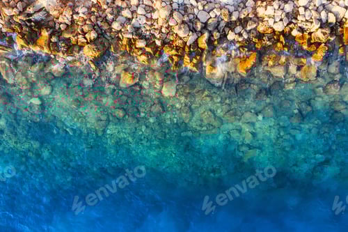 Preview: Mediterranean sea. Aerial view on water and rocks during sunset. Vacation and adventure.