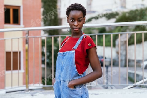 Preview: African woman model posing on the street with an intense and very fashionable look