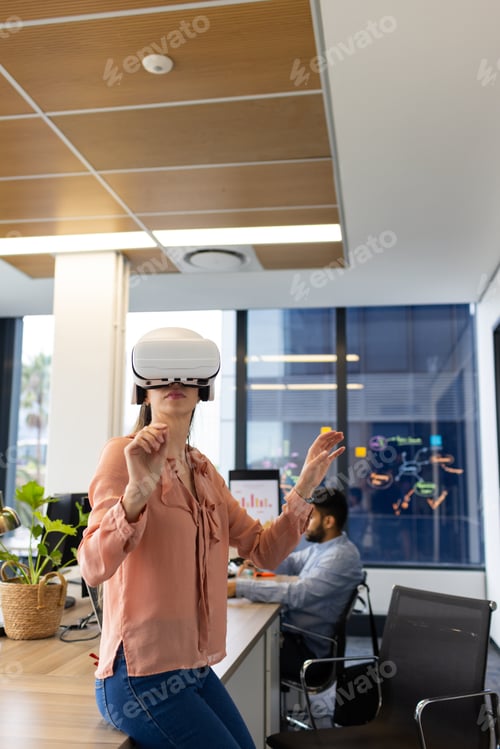 Preview: Using VR headset, woman exploring virtual reality in modern office environment, copy space